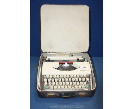 A vintage Olympia De Luxe typewriter with case, zip broken on case.