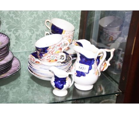 A small quantity of Gaudy Welsh china in Tulip design: four cups and saucers, side plates and three jugs.