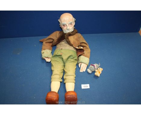 An unusual puppet of an old gent with composite head and hands and wooden body and legs, dressed in handmade clothing, string