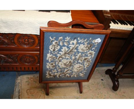 A Mahogany framed Fire screen having a framed tapestry of stylised foliage and flowers against a royal blue background, 19 5/