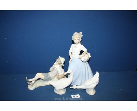 A Lladro figure of a boy sitting (shoe a/f) with two Nao ducks and one other similar.