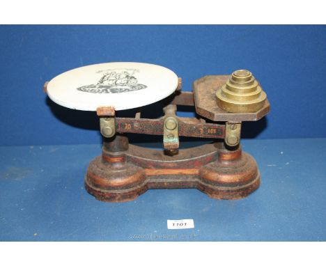 A vintage set of scales with ceramic top and set of weights.
