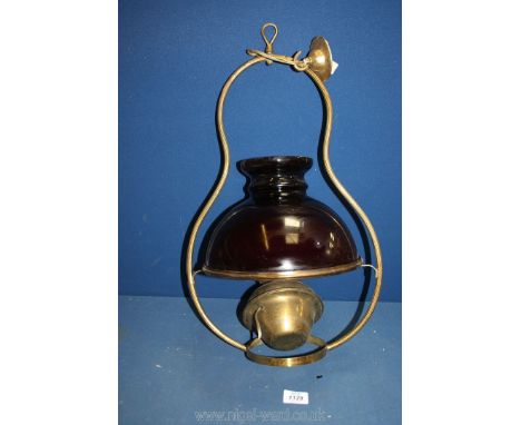 A ceiling fitting oil lamp converted to electric with brass reservoir and frame and dark red/purple over white glass shade.