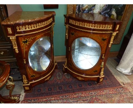 A pair of most ornate Corner Cabinets each having an upper frieze drawer and an oval panel glazed door, the darkwood accentua