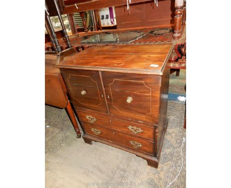 A Mahogany/Walnut commode type double doored Cupboard over two long drawers and raised on bracket feet and with pierced back 