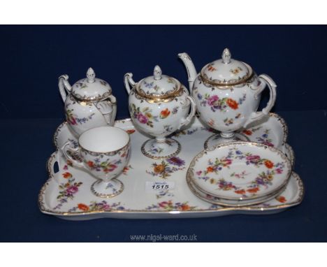 A Dresden style Tea for One set complete with footed teapot, cup, jug and sucrier with lid, two saucers and tray decorated in