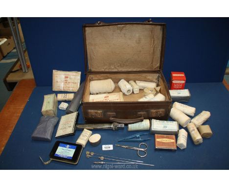A small suitcase and contents of vintage bandages and First Aid items.