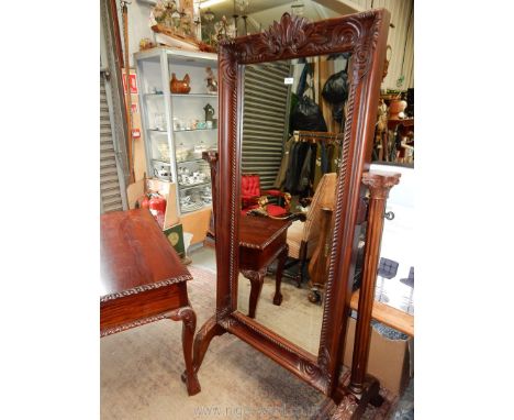 A substantial Mahogany framed Cheval/Robing Mirror supported on reeded pillars with Corinthian column design on splayed feet 