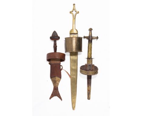 **NO RESERVE**A Lot of Three African Arm Daggers with Brass and Leather Sheaths.A lot of three arm daggers. The first feature