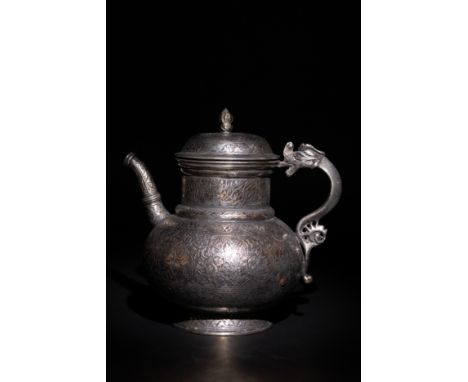 An Islamic Timurid Copper Ewer with Engraved Calligraphy and Dragon Handle.A copper ewer featuring an bulbous body adorned wi