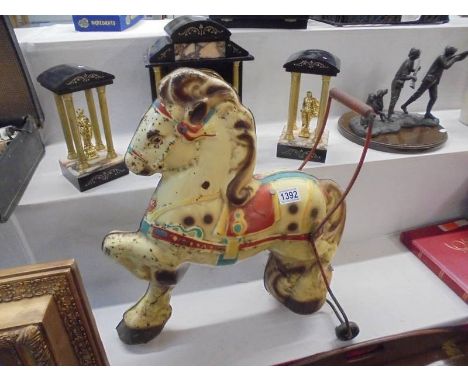 A Mobo tin plate push along horse. COLLECT ONLY.