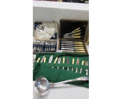 A set of silver plate fish knives &amp; forks with silver bands, 2 other cutlery sets and a large soup ladle.