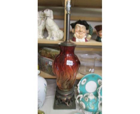 A tall red glass table lamp on metal base, will need re-wiring, COLLECT ONLY.