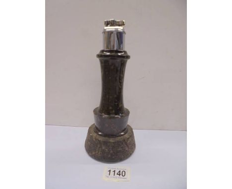 A tall Cornish Serpentine lighthouse table lighter, 25 cm tall.