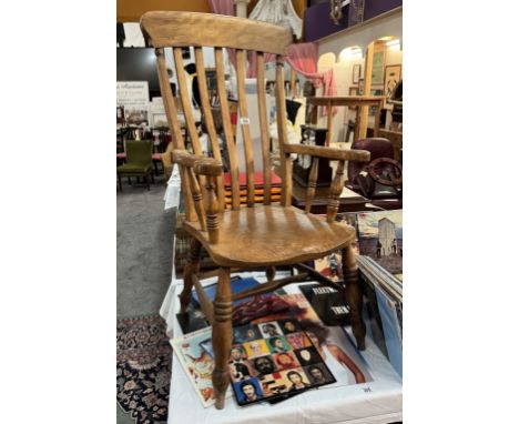 A Victorian oak stick back carver chair