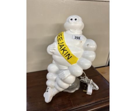 A Michelin man truck mascot repurposed as a table lamp with Meejakin branded sash