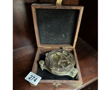 A brass nautical compass / sundial in teak box