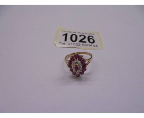 A 9ct yellow gold ruby and diamond ring, size N, 2.4 grams.All stones present.Looks in good condition