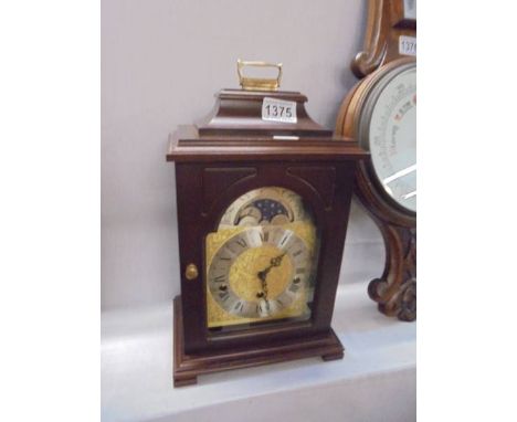 A modern mahogany bracket clock.