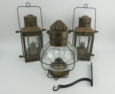 A pair of&nbsp; Davey &amp; Co copper and brass ship's oil lamps and a globe Davey &amp; Co ship's lamp with iron wall bracke