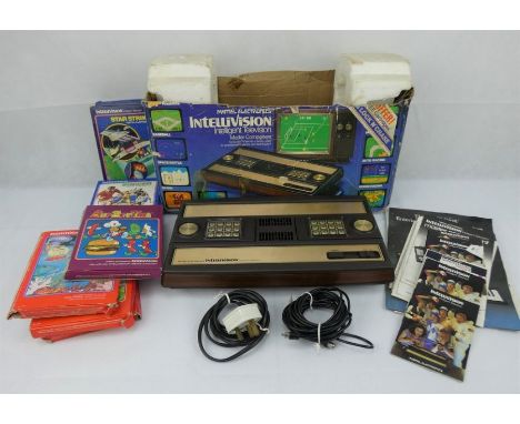 An early 1980s Mattel Intellivison games console, 8 games and various manuals.