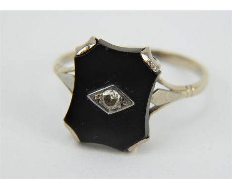 An Art Deco white gold black onyx set ring with central diamond. Size U. Gross weight: 2.9 grams.