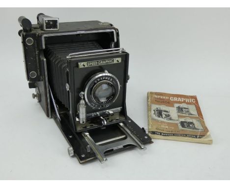 A Graflex Speed Graphic large format folding bellows camera with f4.5 lens, and instruction manual.