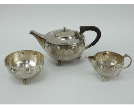 Three piece planished silver Arts &amp; Crafts tea set. Hallmarked Birmingham 1911, Maker A E Jones. Each piece with planishe