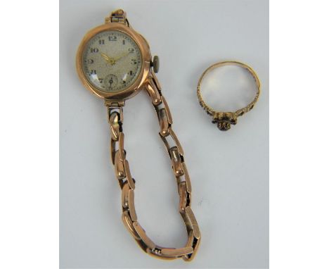 A 9ct gold ladies wrist watch &amp; bracelet and a garnet set 9ct gold ring size N.&nbsp; Combined gross weight: 17.2 grams