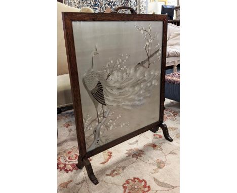 ARTS AND CRAFTS FIRESCREEN, early 20th century, oak frame and cream silk embroidered peacock panel, 85cm H x 62cm W. 