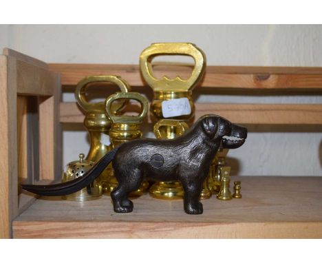 A set of brass weights together with a nut cracker formed as a dog