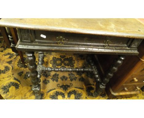 An oak single drawer side table on bobbin turned supports in the 17th Century manner