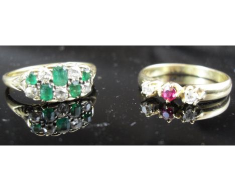 An 18 carat gold diamond and emerald set dress ring, together with an 18 carat gold diamond and ruby set dress ring CONDITION