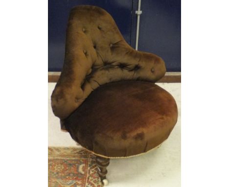 A Victorian button-back corner chair raised on a winged and turned legs to brass caps and china castors in brow velour uphols