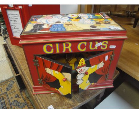 A modern hand painted "Circus" musical box and a three prong hay fork