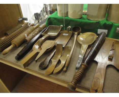 A collection of 16 mainly 19th Century items of treen ware to include unusual patterned rolling pins, sifter ladle, butter mo