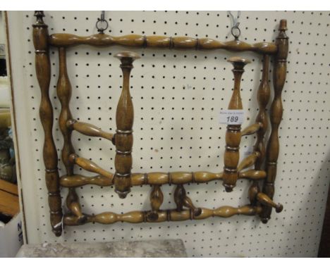 A circa 1900 stained beech bobbin turned adjustable hat and coat rack wall mounted