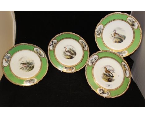 A set of four early 19th Century Spode cabinet plates, the centre field decorated with birds within a grained round band set 