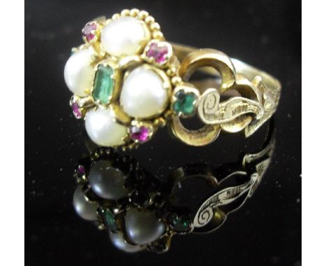 A Victorian yellow metal ring set with pearls, emeralds and rubies, flanked by pierced shoulders CONDITION REPORTS Size P/Q. 