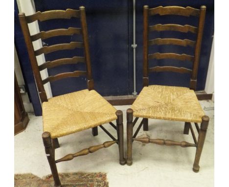 An oak drawer leaf dining table, four rush seat ladder back chairs, a Lloyd Loom tub chair, pine Tyrolean style panel seat ch