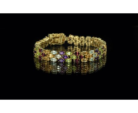 Amethyst, Peridot, Blue Topaz, Garnet and Citrine Line Bracelet, 22cts; rows of each gemstone forming chevron shapes, closely