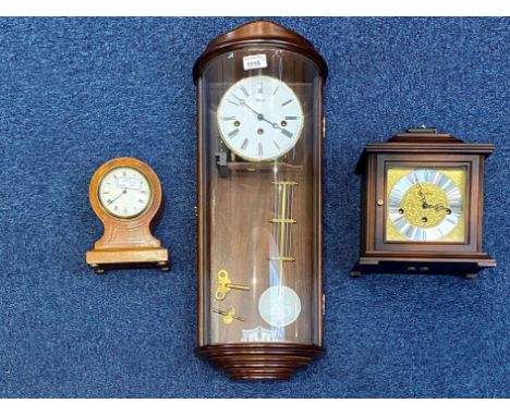 Collection of Clocks, comprising a Hermle cased pendulum glass fronted wall clock, white dial, Roman numerals.  Measures 24''