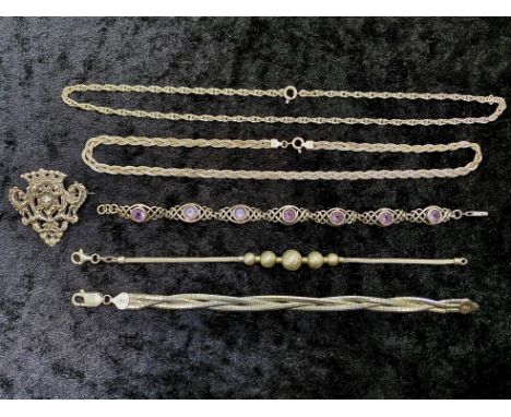 Small Collection of Silver Jewellery, comprising a three strand twist bracelet, a silver brooch in a scroll shape with a coro