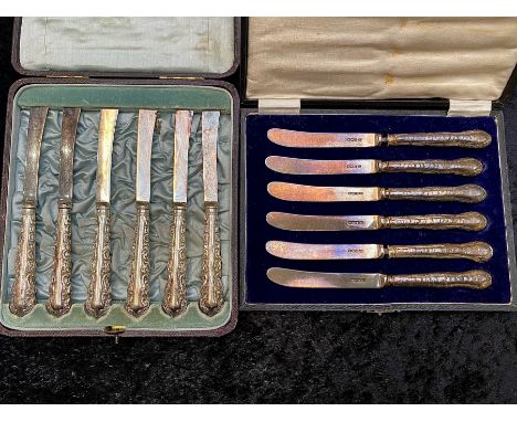 Two Edwardian Silver Butter Knives in original fitted ,cases, one set with silver blades and handles, the other with silver h