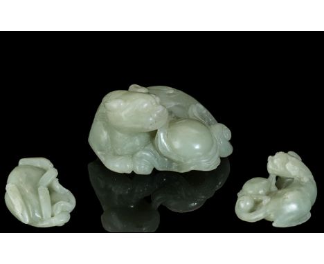 A Chinese Carved 18th / 19th Century Jade Sculpture of a Recumbent Foo Dog with Ball. Size 2 Inches - 5 cms Wide. Weight 82.3