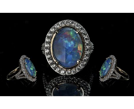 Ladies Superb 9ct Gold Black Opal and CZ Set Cluster Ring, full hallmark for 9.375 to shank; the large, oval shaped black opa