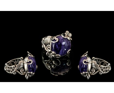 Russian Charoite Ring, a 12.75ct cabochon cut charoite set in a decorative, hand crafted, silver mount with flowers and loops