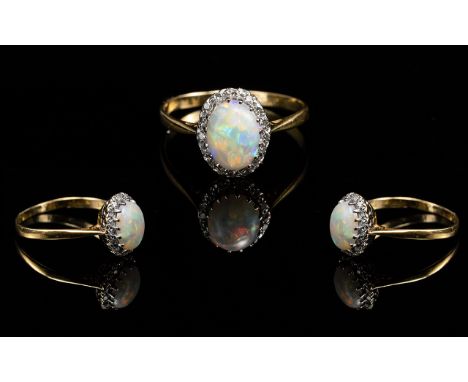 Antique Period 18ct Gold Attractive Opal and Diamond Set Ring, the central opal, of excellent colour, surrounded by sixteen s