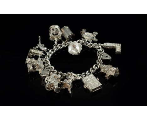 A Vintage Sterling Silver Charm Bracelet - Loaded with 12 Good Quality Sterling Silver Charms. All Marked 92.5. Comprises Tow