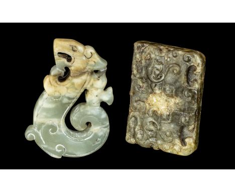 A Pair of Jade Amulets in the archaic style, one in the form of a dragon 2.5'' x 1.75'', the other a tablet.